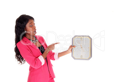 Surprised woman holding clock