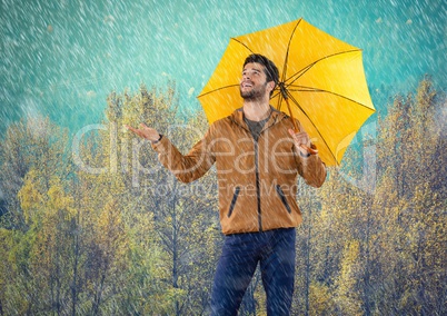 Man in Autumn with umbrella in forest of rain