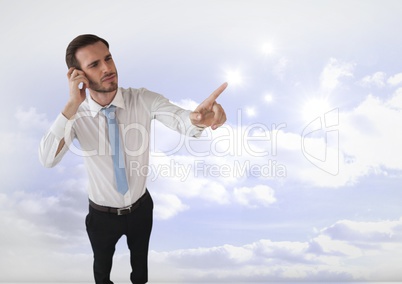 Businessman touching sparkles in clouds