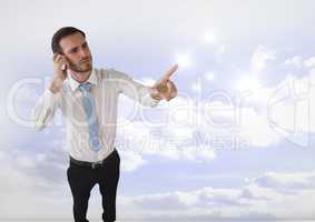 Businessman touching sparkles in clouds