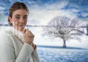 Woman in white warm jumper with snow landscape and bare tree