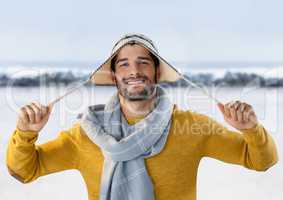 Man with warm hat and scarf in snow landscape