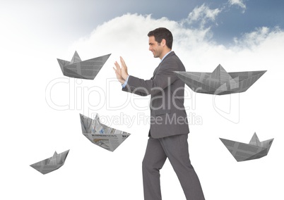 Businessman with paper boats