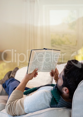 Man in Autumn with book in dreamy home landscape