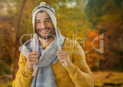 Man in Autumn with hat and scarf in forest