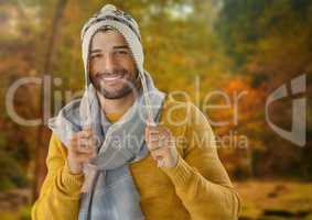 Man in Autumn with hat and scarf in forest