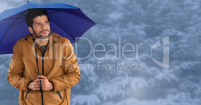 Man with blue umbrella in blue snow forest