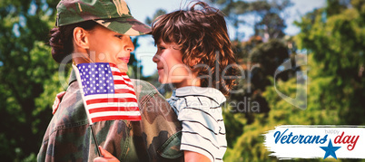 Composite image of army woman carrying son