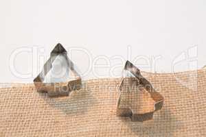 Cookie cutters on textile against white background