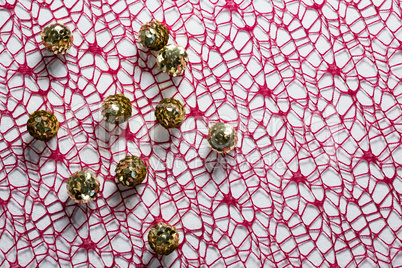 Sequin balls on pink fabric