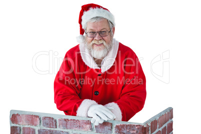 Santa claus leaning on the chimney against white background