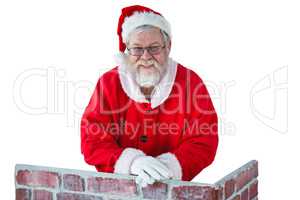 Santa claus leaning on the chimney against white background