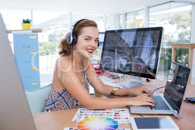 Smiling executive working on laptop in office