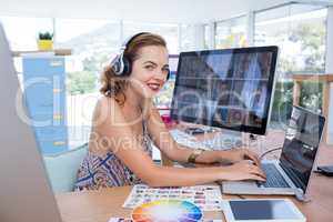 Smiling executive working on laptop in office