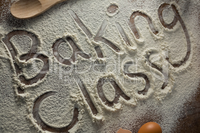The word baking class written on sprinkled flour