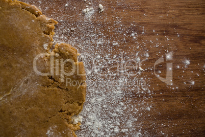 Flattened dough on a wooden table