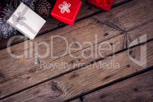 Gift boxes and christmas decorations on wooden plank