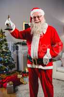 Santa claus ringing a bell at home