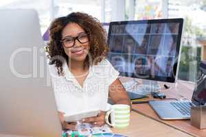 Female graphic designer using digital tablet in office