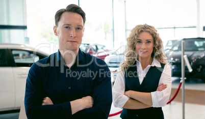 Portrait of entrepreneurs standing in car showroom