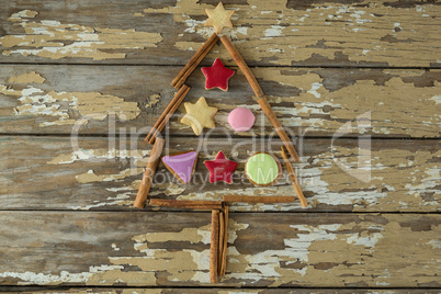 Cookies and cinnamon arranged in christmas tree shape