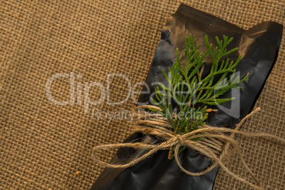 Close up of packet and pine twig tied with rope