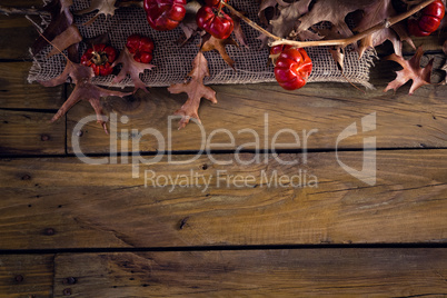 Dry leaves and mistletoe on wooden plank