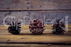 Pine cones on wooden plank