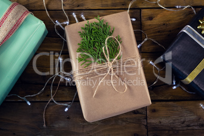 Gift boxes and christmas light on wooden plank