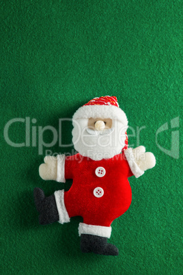 Handmade santa on green background