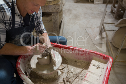 Male potter making a pot