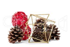 Pine cones and christmas decoration against white background