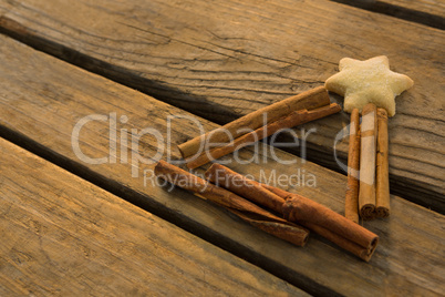 High angle view of star shape cookie with cinnamon sticks