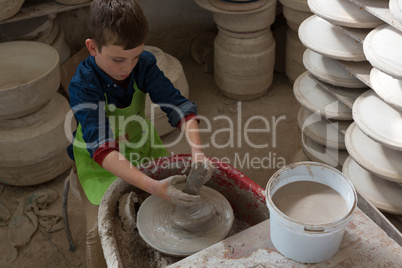 Boy making a pot