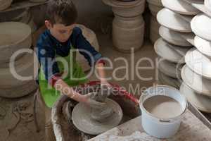 Boy making a pot