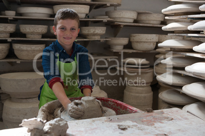 Boy making a pot in pottery workshop