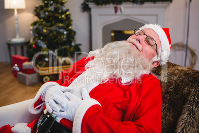 Santa claus relaxing on sofa in living room at home