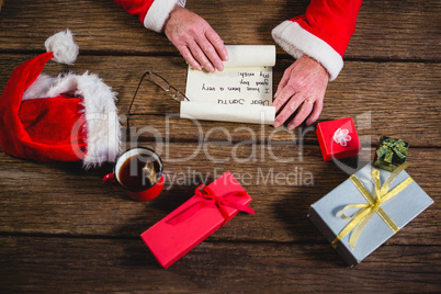 Hands of Santa Claus opening scroll
