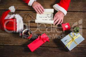 Hands of Santa Claus opening scroll