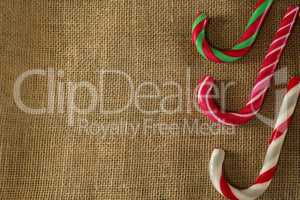 Multicolored candy canes arranged on fabric