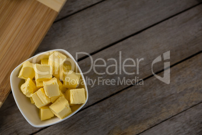 Cheese cubes in a bowl on wooden table