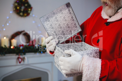 Santa claus opening the gift box