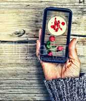 display image of strawberry milkshake Healthy Eating Smartphone in a female hand.