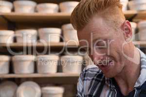 Male potter working in pottery workshop