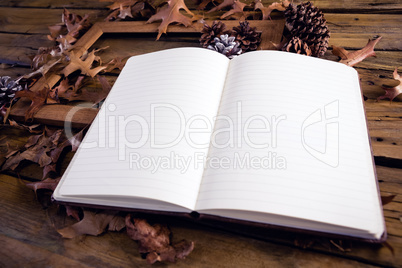 Open book and frame on wooden table