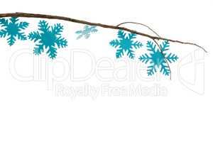 Snowflakes decorated on branch against white background