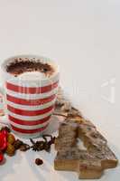Coffee with cinnamon powder and christmas decorations