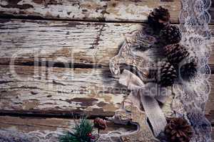 Christmas decoration and lace on wooden plank