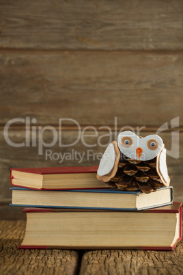 Book stack and christmas decoration on wooden plank