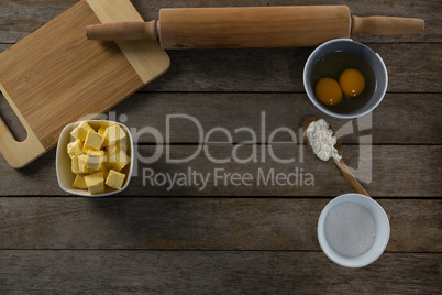 Cheese cubes and egg yolk on a wooden table